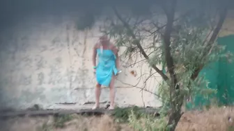 2 Russian women peeing behind shed