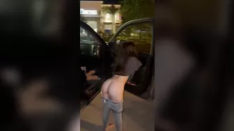 Sammie wetting her jeans in a parking lot