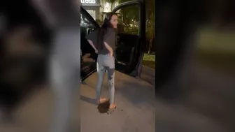 Sammie wetting her jeans in a parking lot