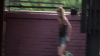 Girl caught peeing behind a wall