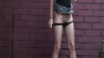 Girl caught peeing behind a wall